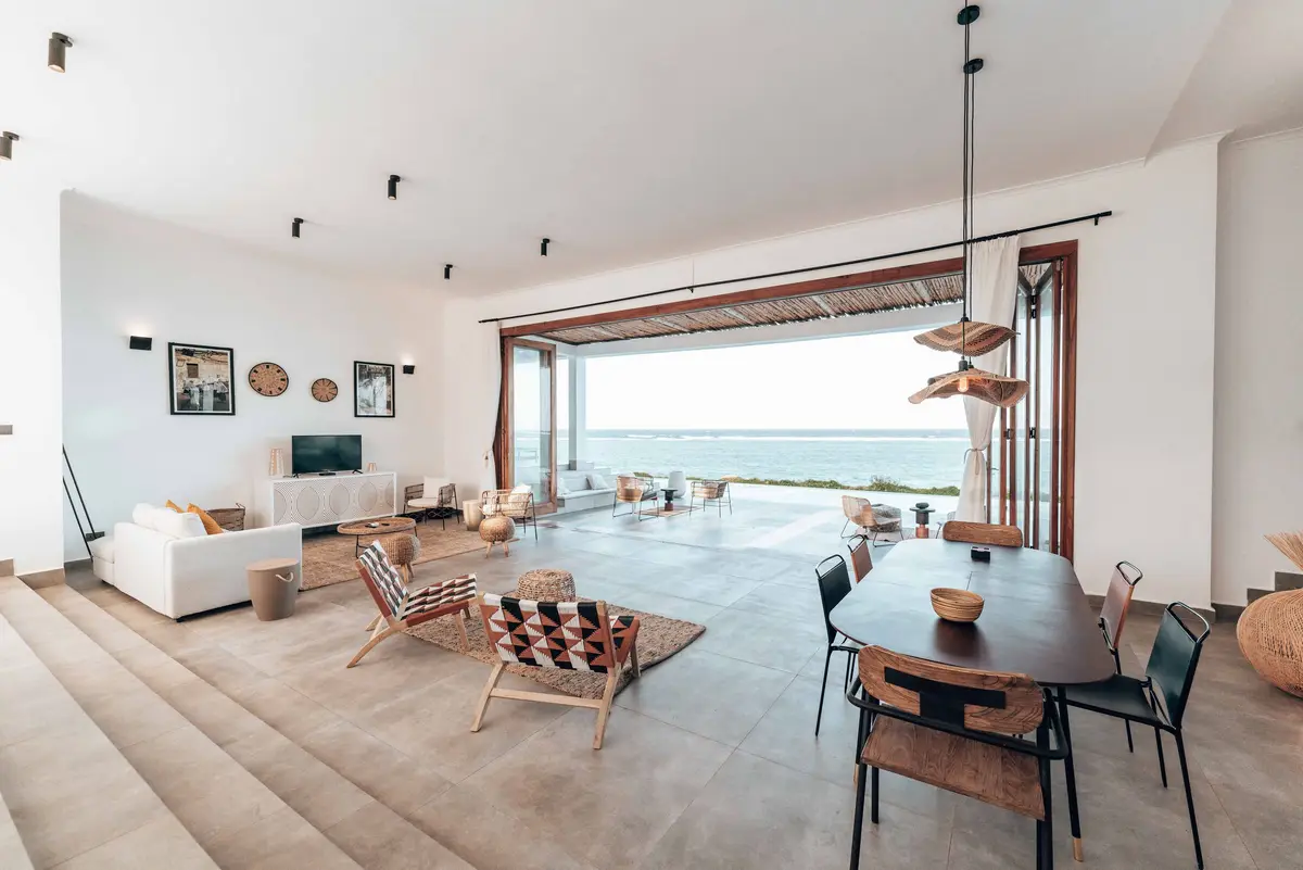 Bright beach house living room with ocean view
